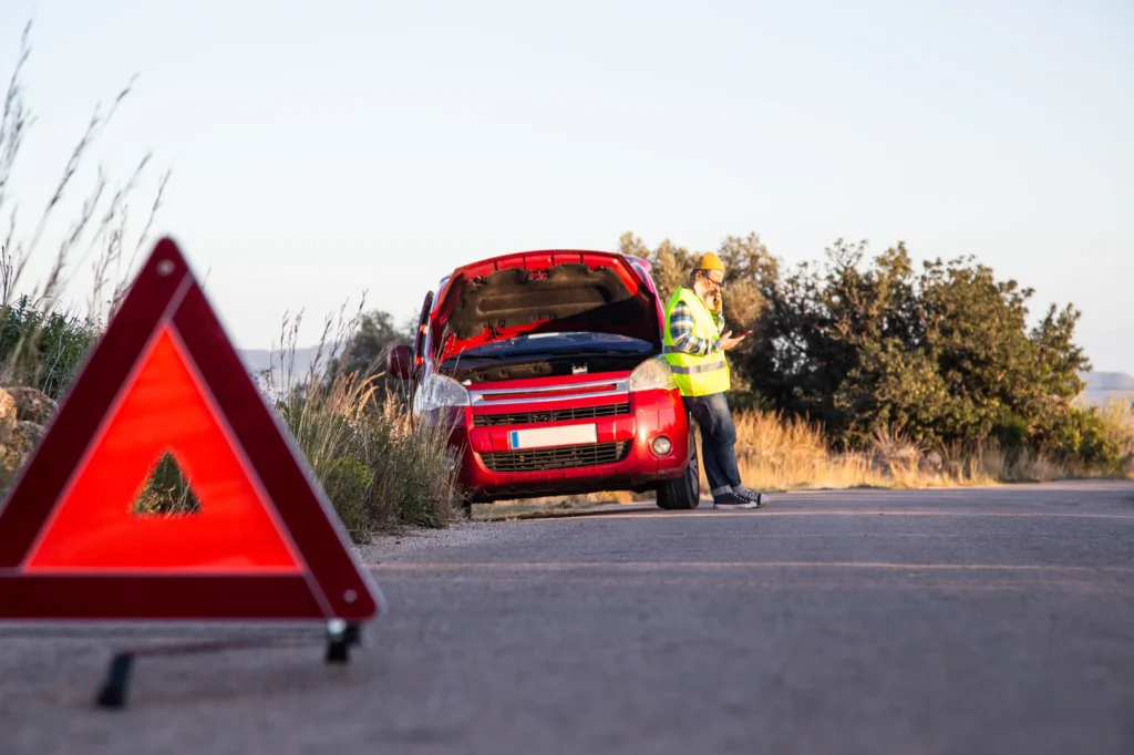 A man stranded on the road calling some help.